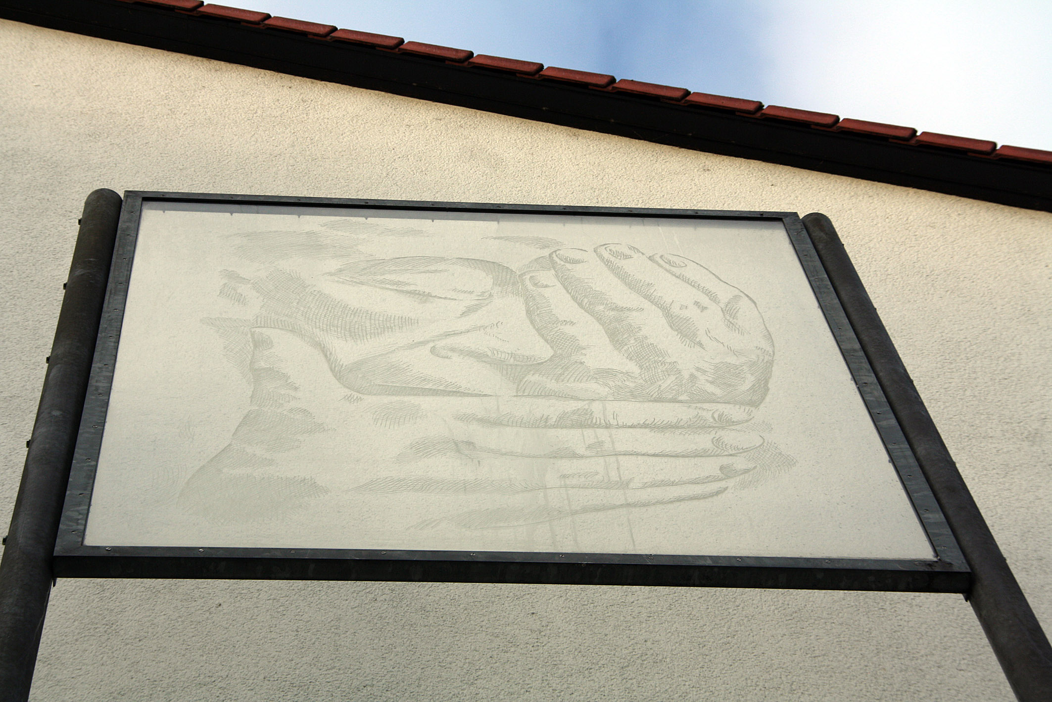 Das Relief „Die Klage. Selbstbildnis um den Tod Barlachs klagend“ von Käthe Kollwitz