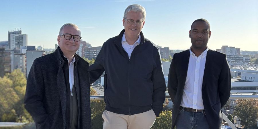 gewobau Geschäftsführer Torsten Regenstein, OB Patrick Burghardt und gewobau Abteilungsleiter Lian Moiba auf dem Dach des modernisierten Wohnhochhauses im Borngraben